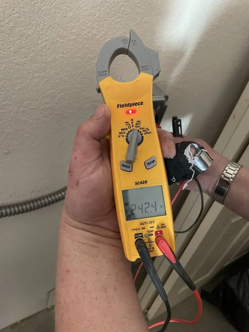 Voltage testing with clamp meter during Outlet Installation in Oswego
